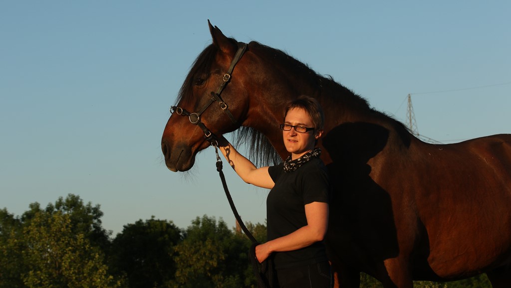 Photograph of transcriber "Dilla" with one of her favorite horses.